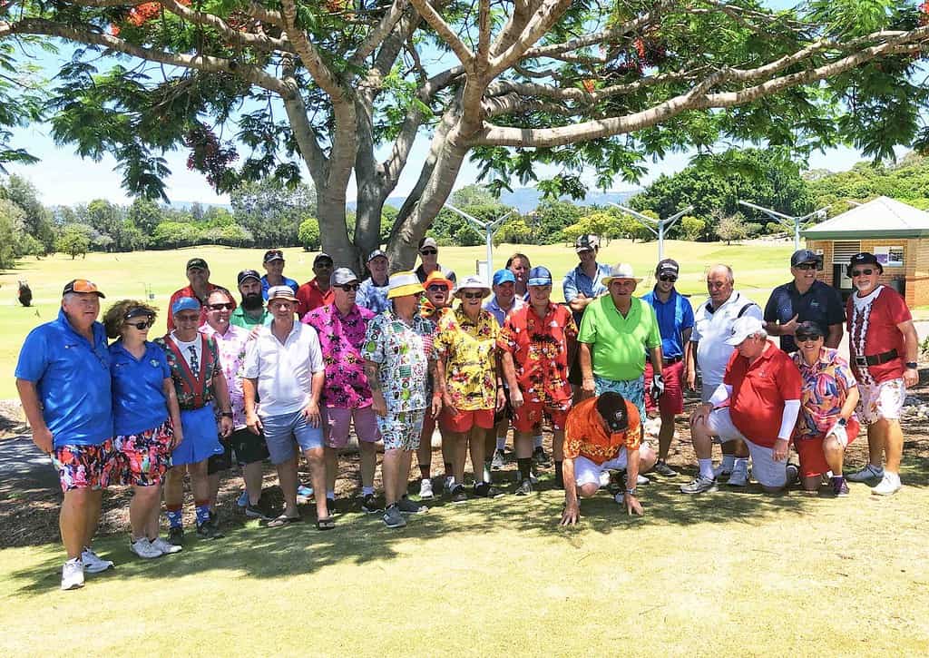 Golf Club members smiling wearing bright Hawaiian shirts.