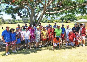 Golf Club members smiling wearing bright Hawaiian shirts.