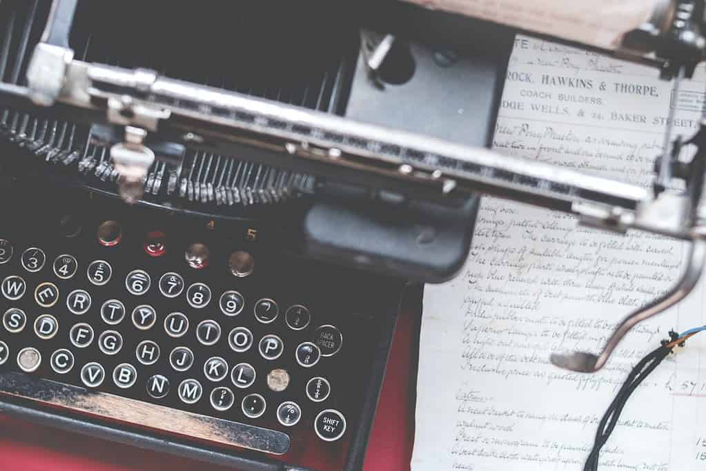 Vale, my friend. A black typewriter sits on the desk. Below it are handwritten letters.
