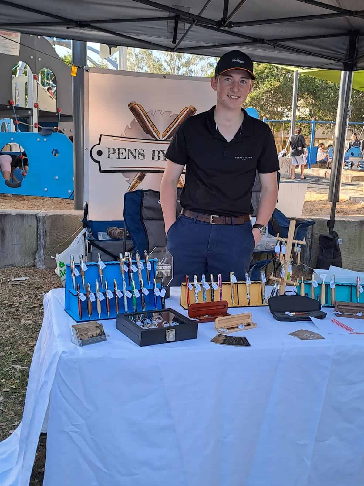 Mackenzie Robinson, a student at Saint John’s Anglican College, selling hand-carved pens at the Forest Lake Community Festival markets. Photo: Corin Mackay, The Lake News.