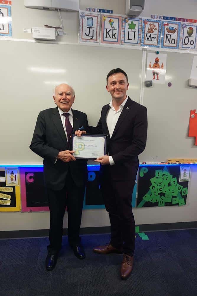 John Howard (left) being presented with his Honorary Membership to the History Club by Keegan Peace (right).